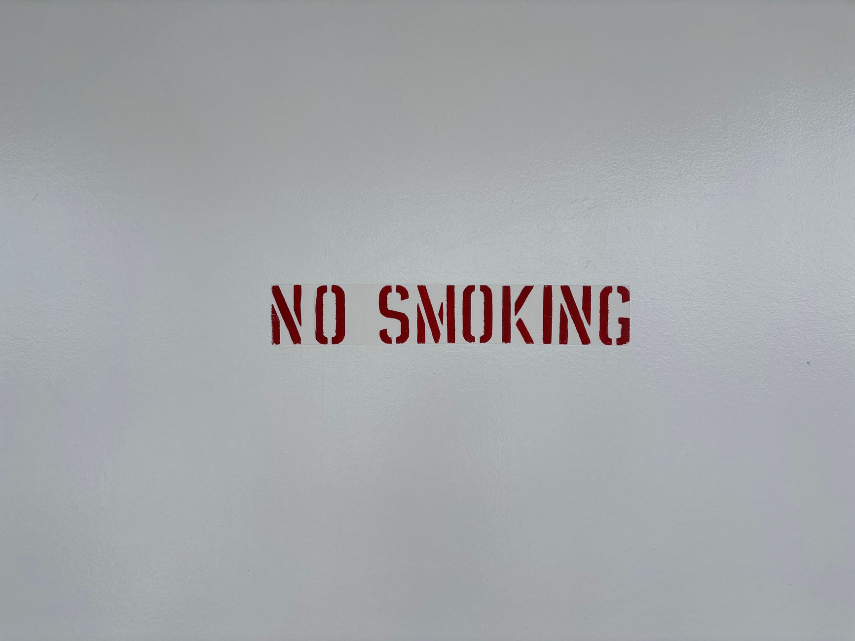 minimalist no smoking sign on grey wall