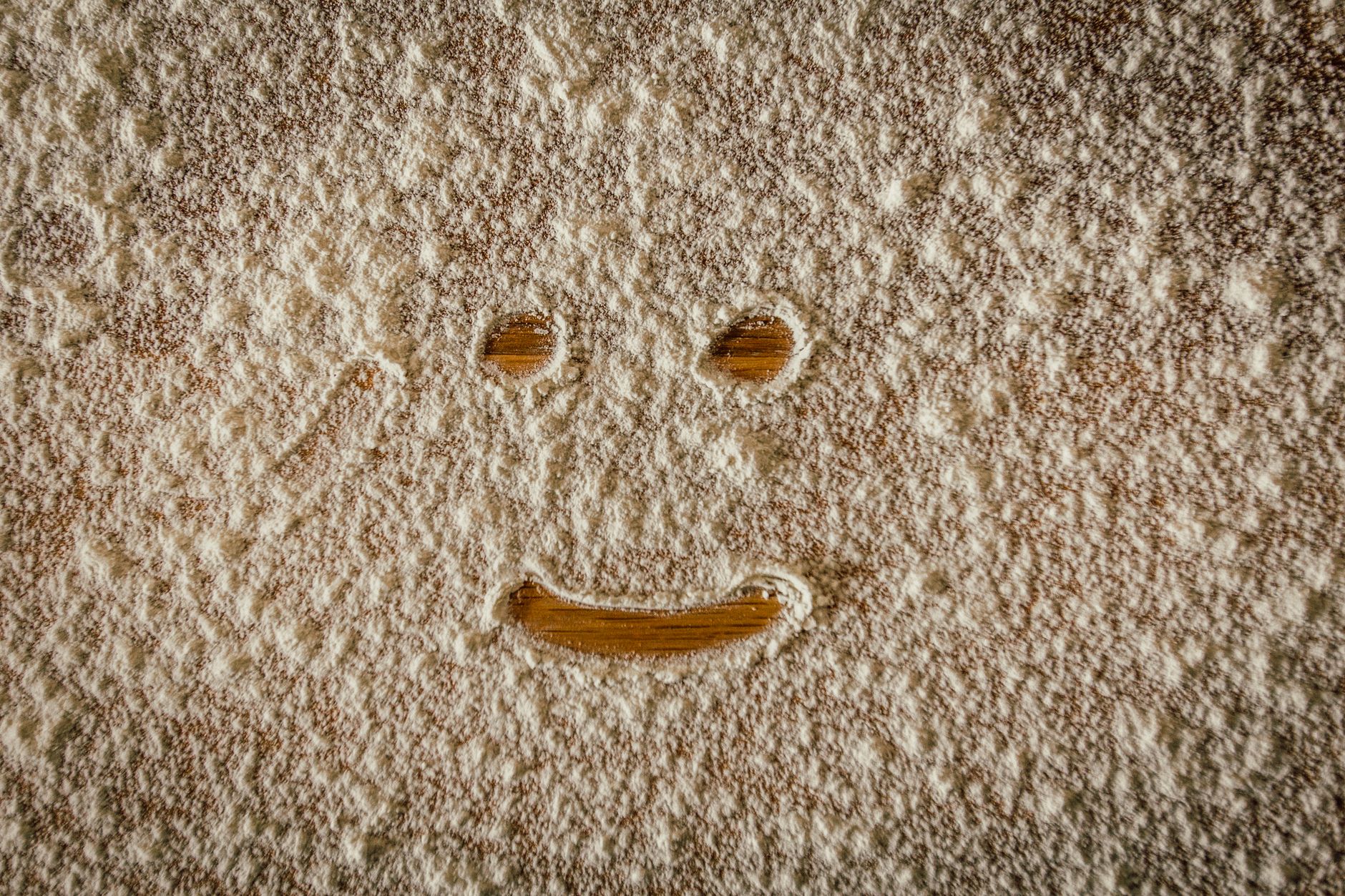flour with smiling face on parquet flooring